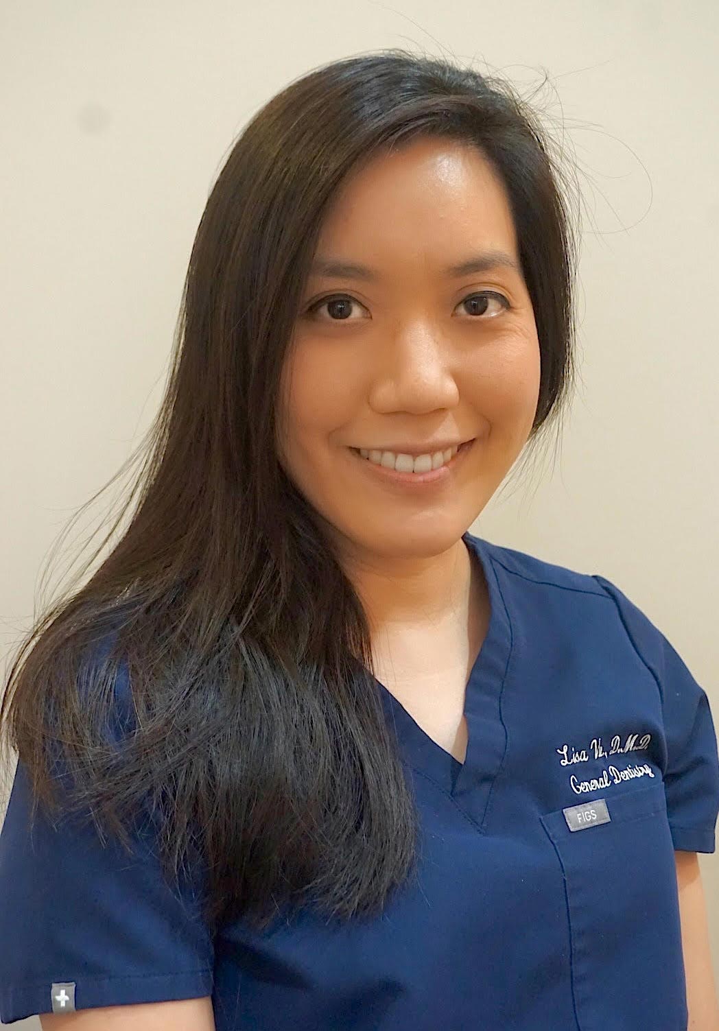 The image features a woman wearing a blue scrub top and smiling at the camera.